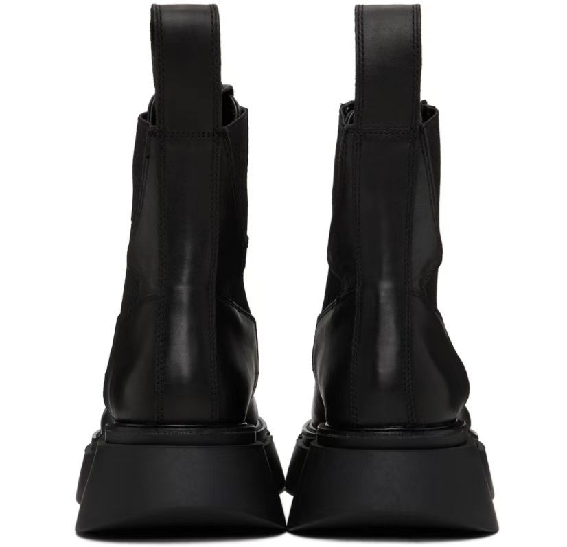Pair of black high-heeled boots on a white background