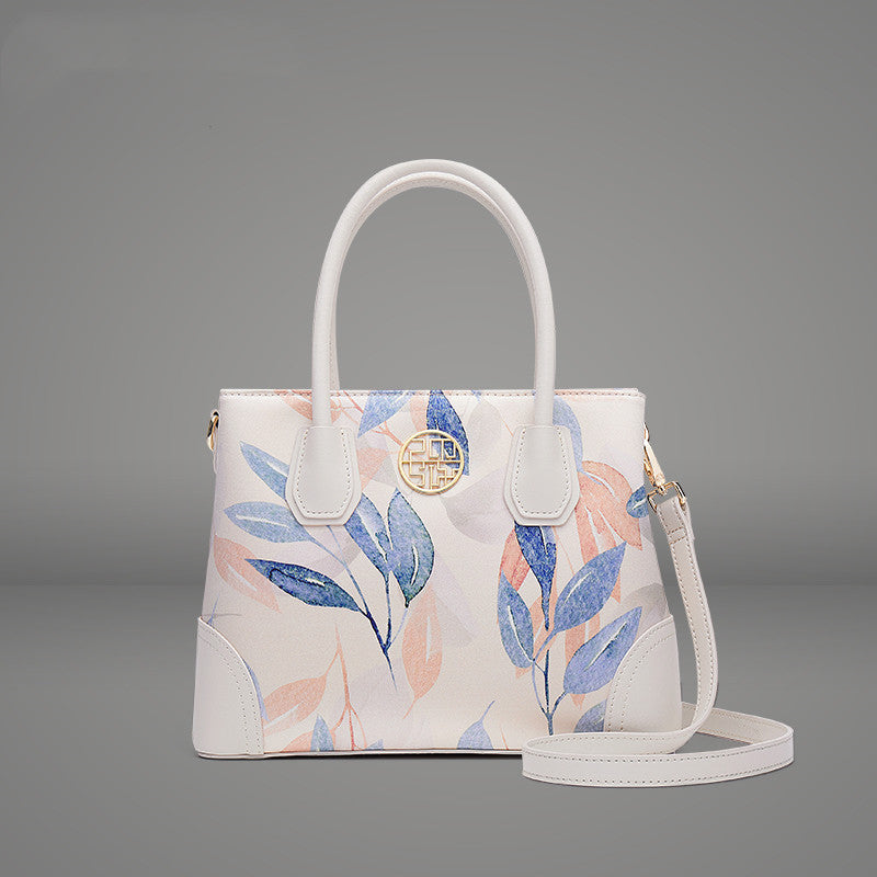Handbag with floral design on a gray background