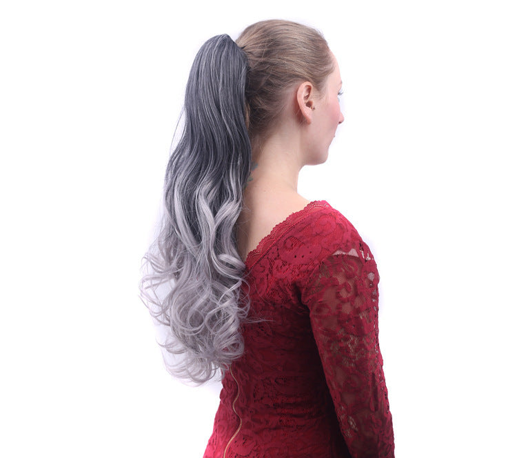 Woman wearing a gray and white ponytail extension on a white background