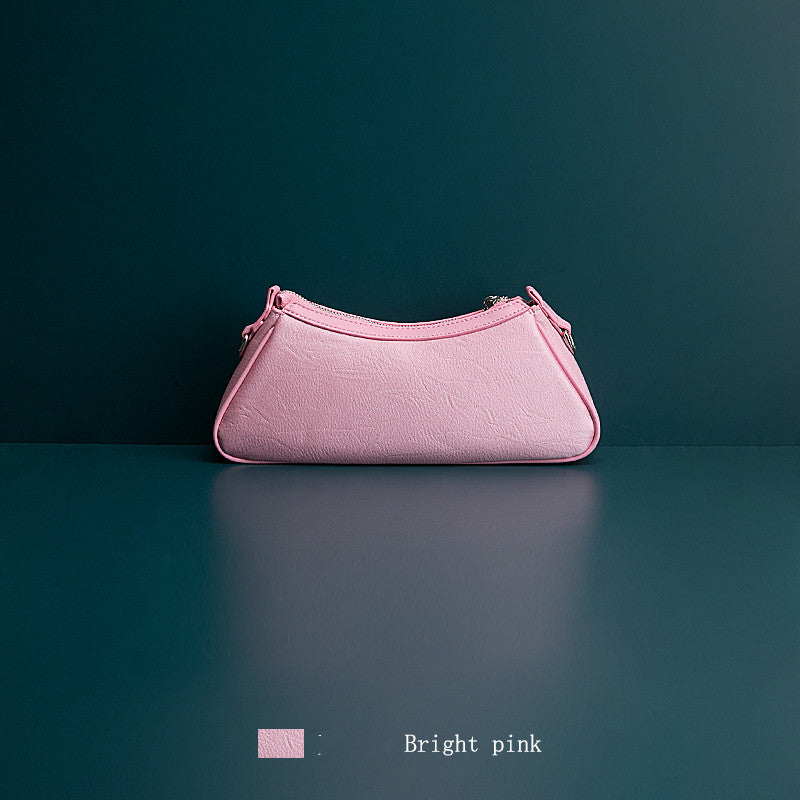 Pink clutch bag on a dark green background