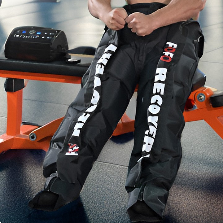 Person wearing black pants with 'RECOVER' branding in a gym setting
