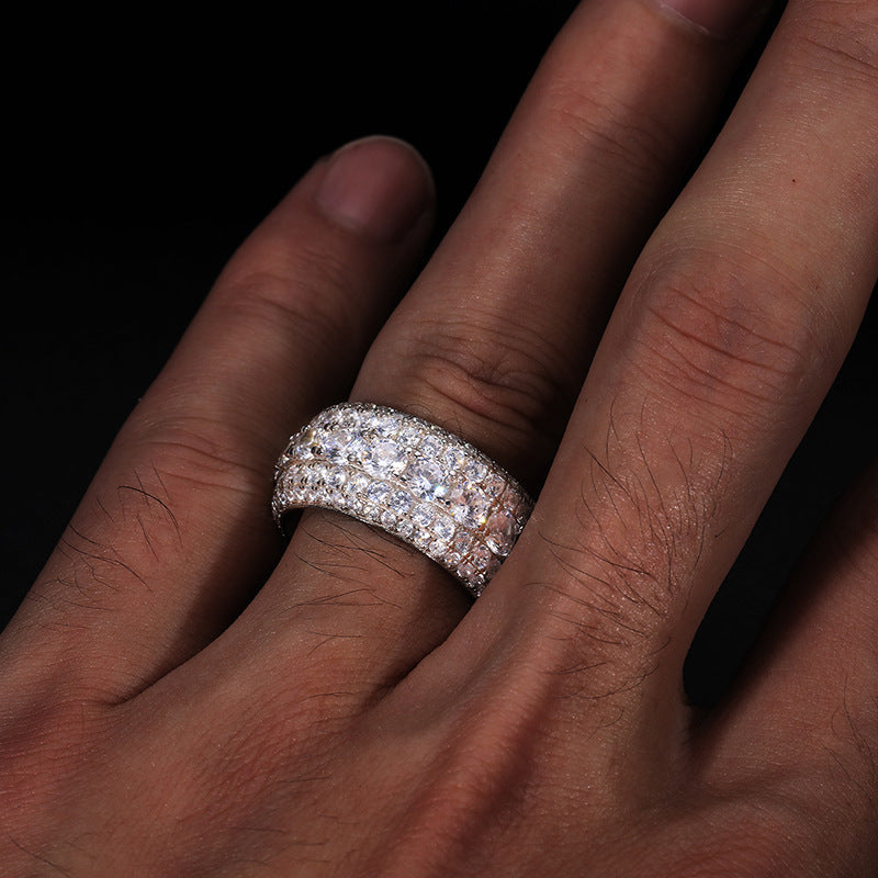 Close-up of a hand wearing a diamond ring on a black background