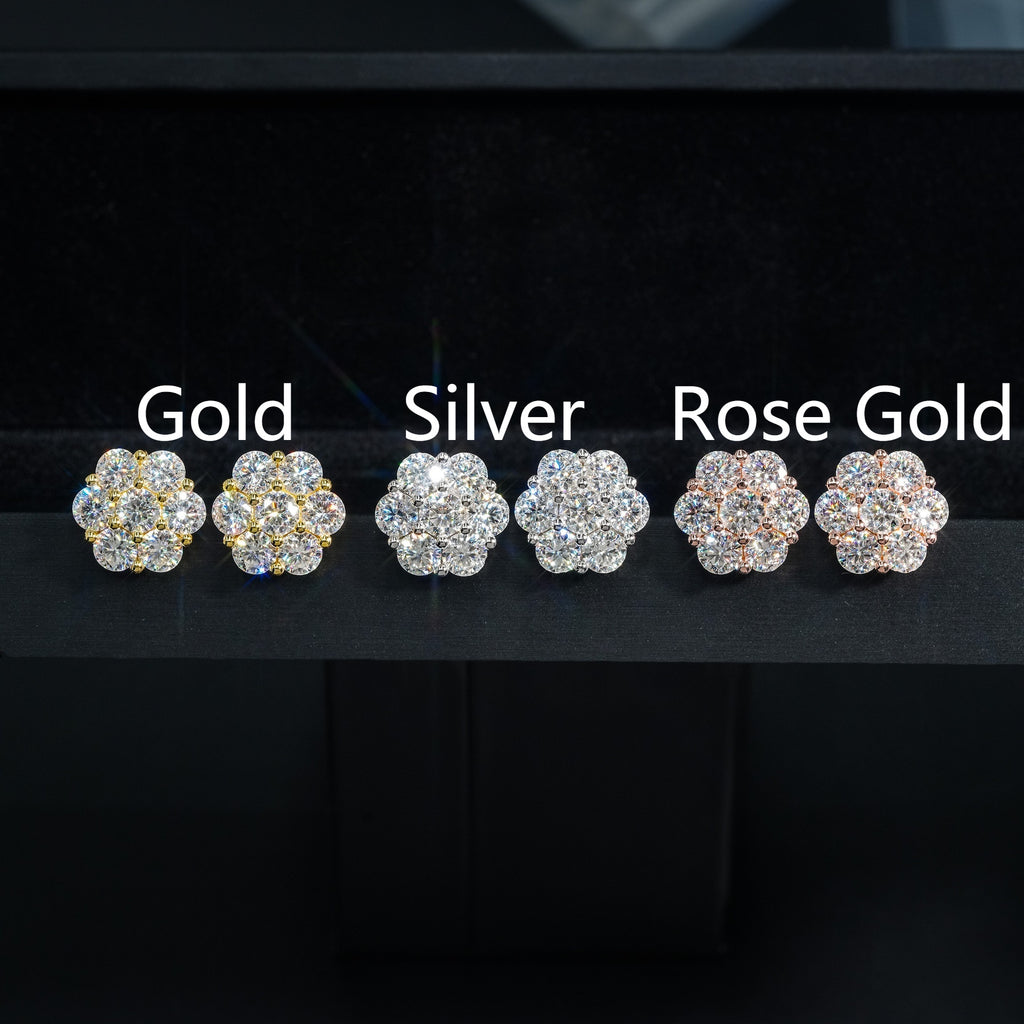Three pairs of earrings in gold, silver, and rose gold on a black background.
