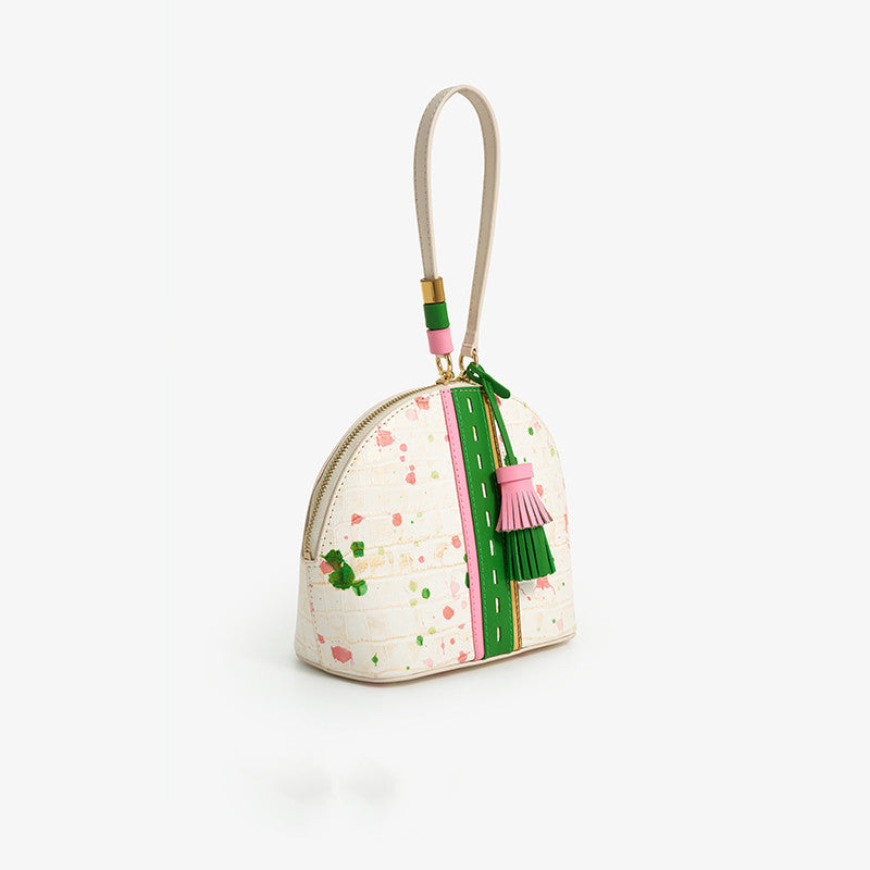 Small handbag with decorative elements on a white background