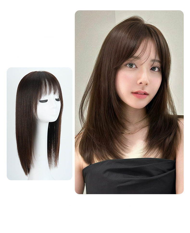 Woman with long brown hair next to a mannequin head with similar hair on a white background