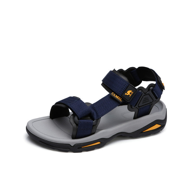 Navy and gray sandal with orange accents on a white background