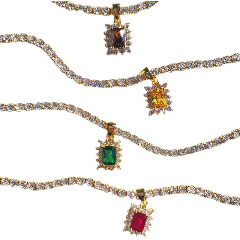 Set of gold necklaces with gemstone pendants on a white background