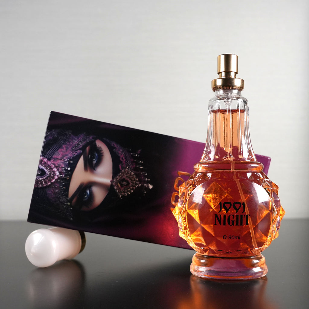 Perfume bottle labeled '1957 Night' with a decorative box on a reflective surface.
