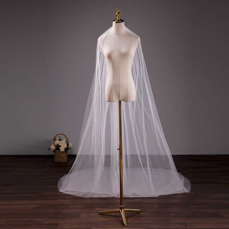 White wedding veil on a mannequin with a dark background