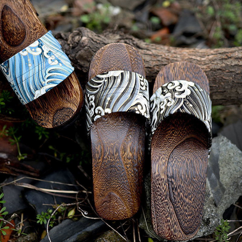 Wooden sandals with wave-patterned straps on a natural background