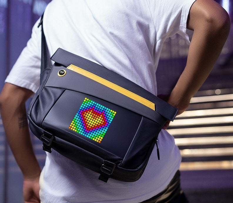 Person wearing a gray bag with a colorful pixelated heart design on a blurred background
