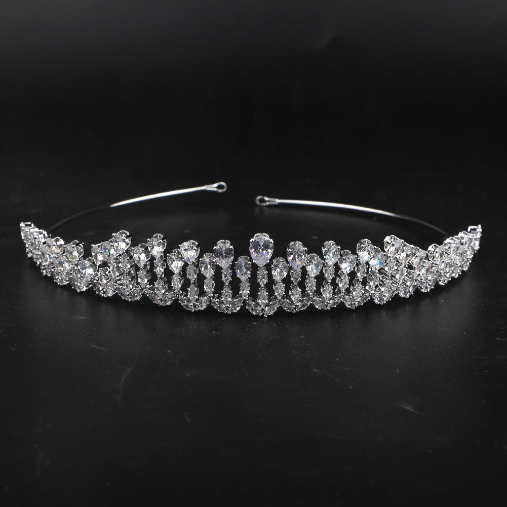 Silver tiara with clear stones on a black background