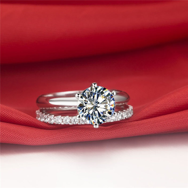 Diamond ring on a red fabric background