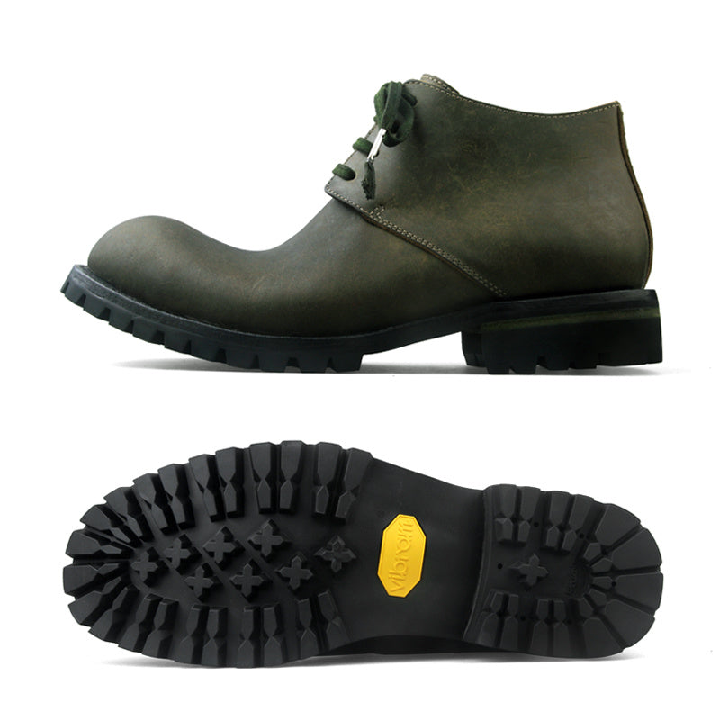 Green leather boot with a close-up of the sole on a white background