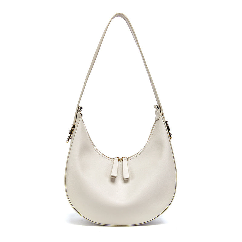 White handbag with gold accents on a white background