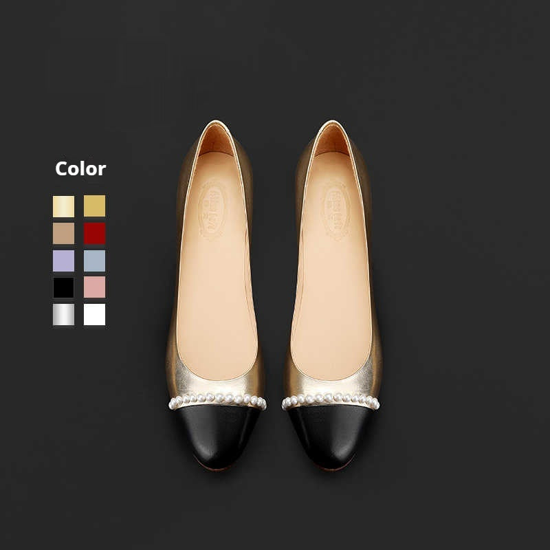 Pair of black and beige shoes with pearl details on a dark background