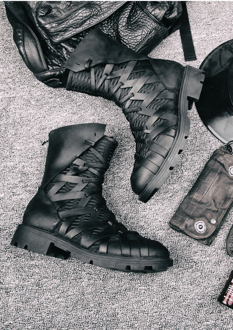 Black leather boots with textured design on a textured surface