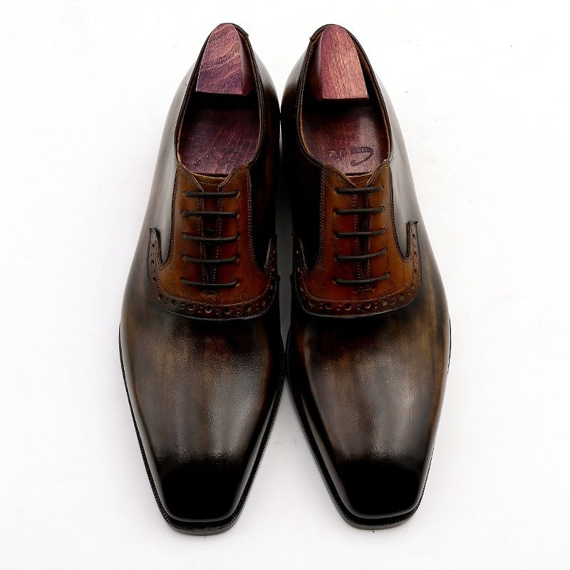 Pair of brown leather dress shoes on a white background