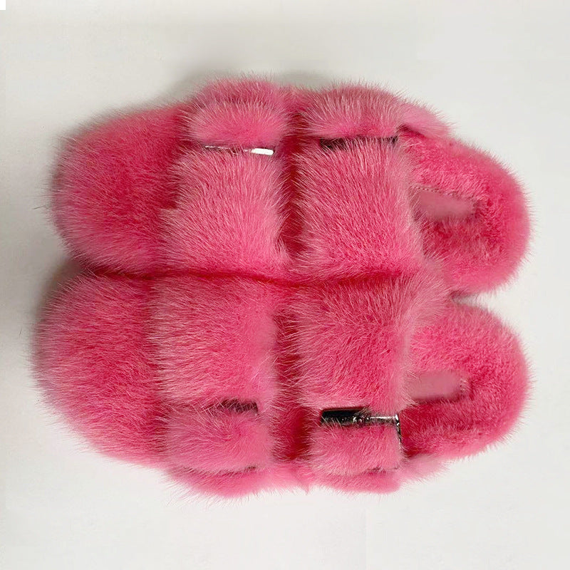 Pink fur gloves on a white background