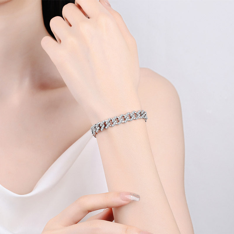 Bracelet on a person's wrist with a plain background