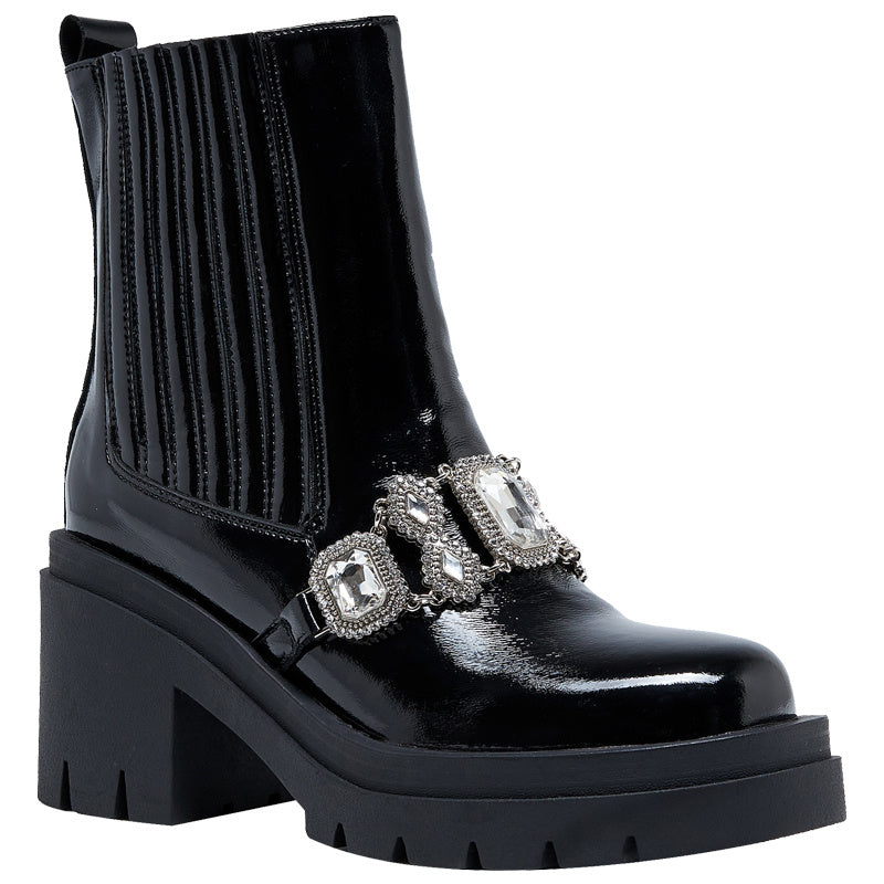 Black patent leather boot with decorative straps on a white background