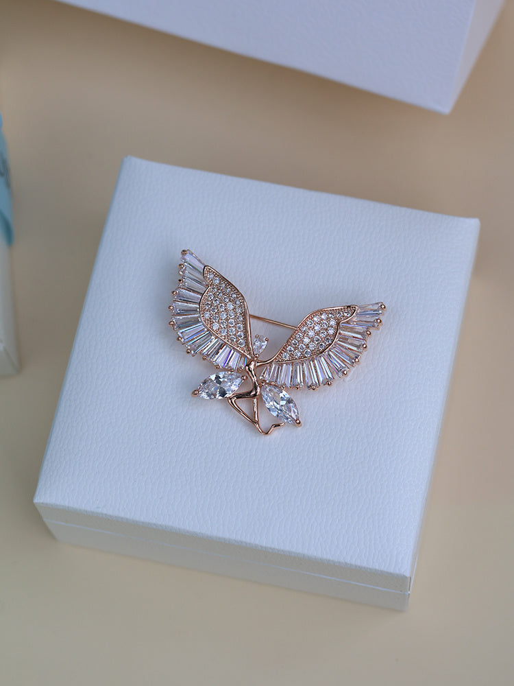Butterfly-shaped jewelry on a white box with a beige background