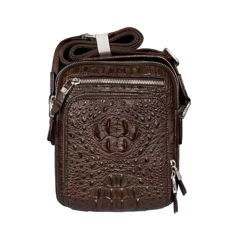 Brown leather crossbody bag with embossed design on a white background