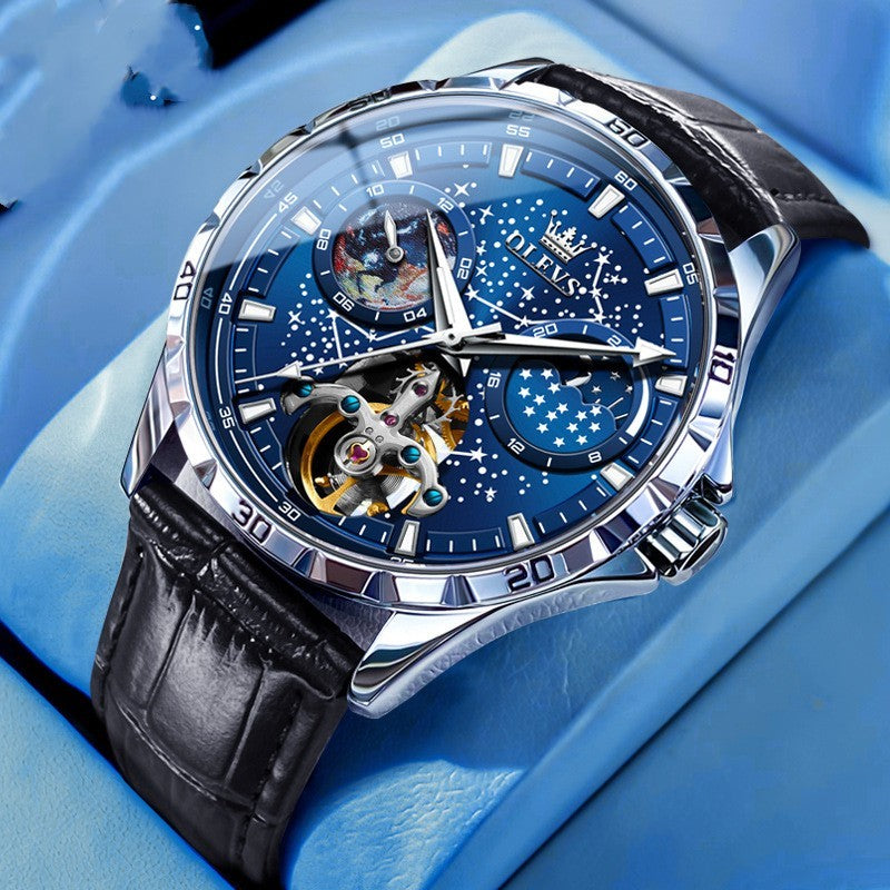 Luxury watch with blue face and black leather strap on a blue background