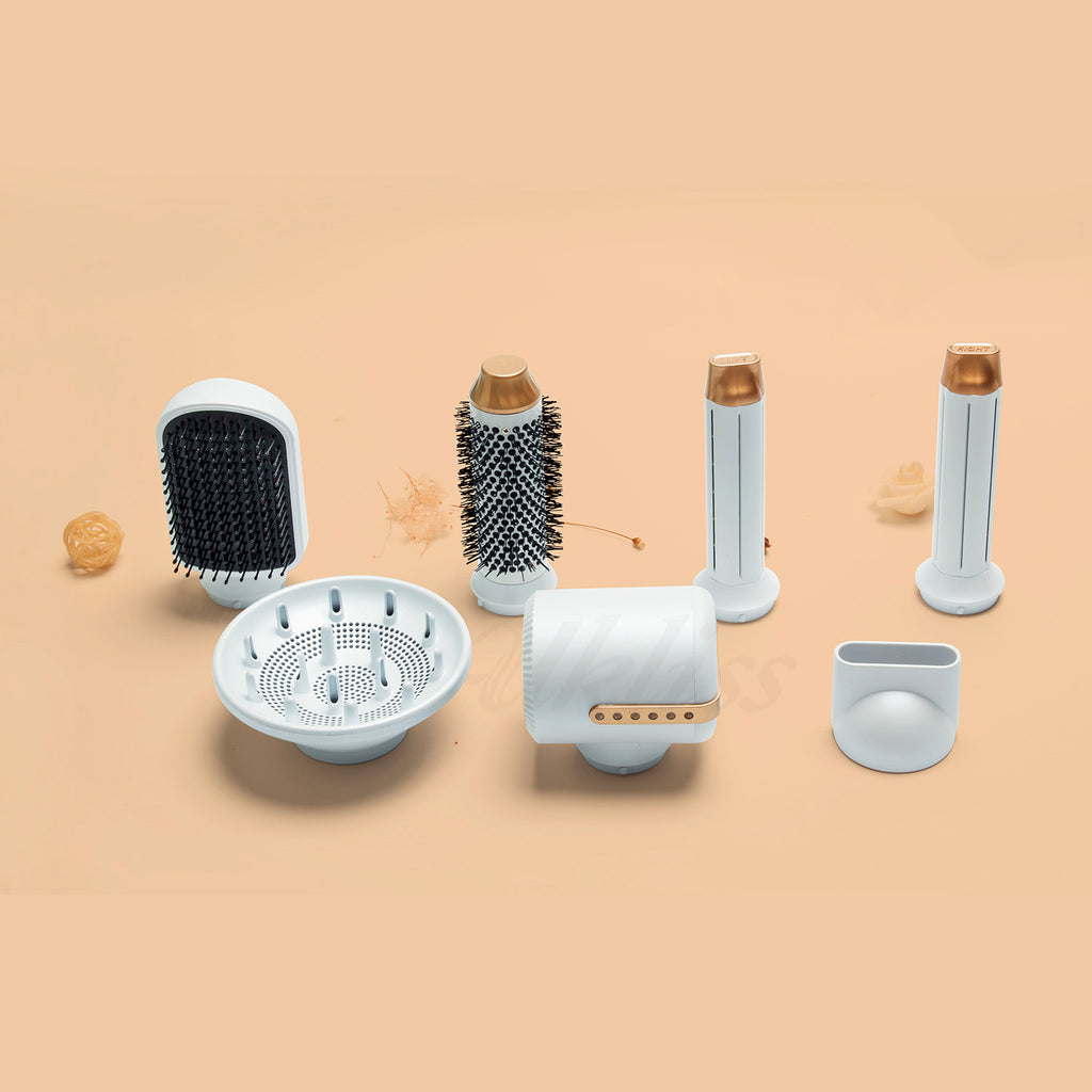 Set of hair styling tools including a brush, diffuser, and attachments on a beige background