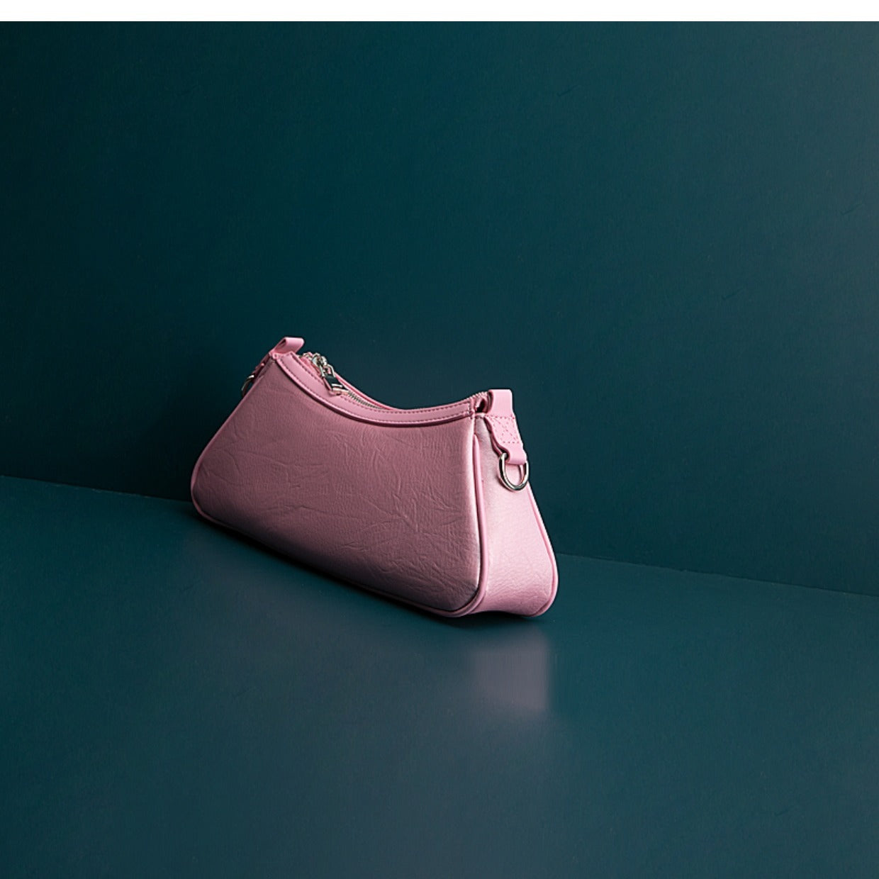 Pink handbag on a dark green background
