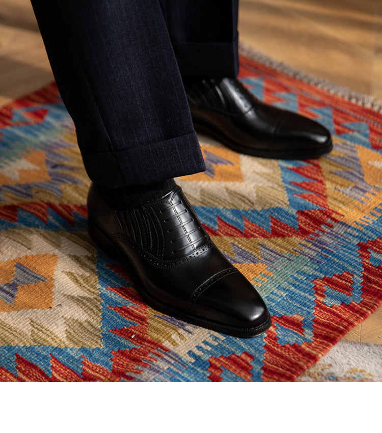 Black dress shoes on a patterned rug