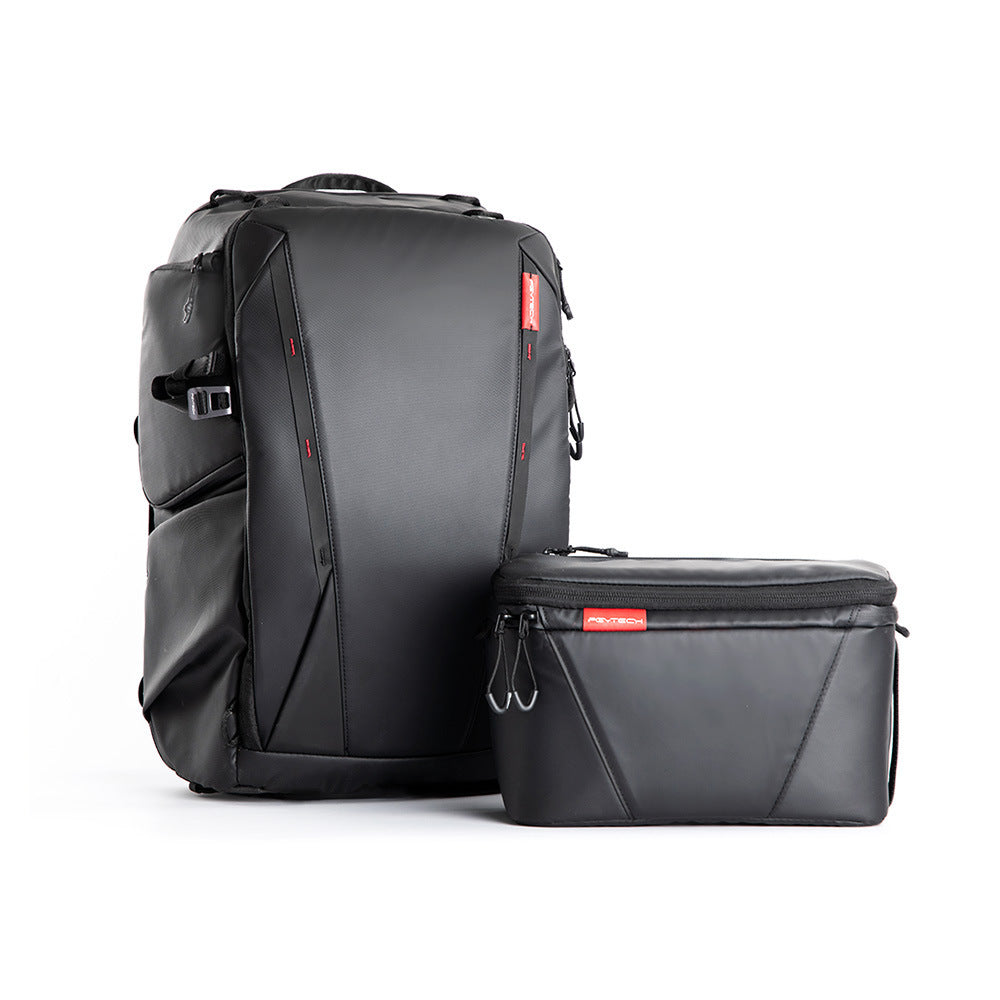 Black travel backpack and suitcase with red accents on a white background