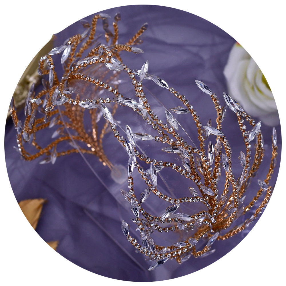 Decorative headband with gold and clear crystals on a purple background